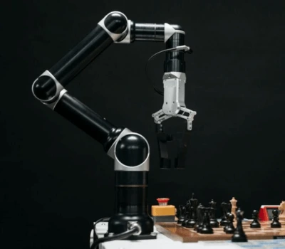 Collaborative robot playing chess with a human, showcasing precision and adaptability in human-robot interaction