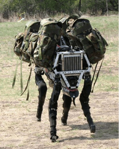 Boston Dynamics' BigDog robot carrying military gear across rough terrain.